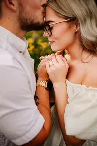 Bride and groom holding hands and touching foreheads during a Jacksonville, Florida wedding.