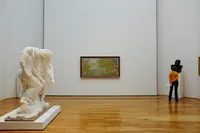 Contemporary art museum gallery with paintings and sculpture