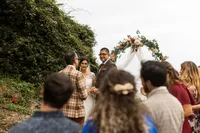 Bride and groom looking at their officiant during the ceremony of a micro wedding in Japan.