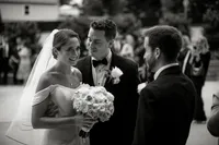 Bride and groom speaking with guests