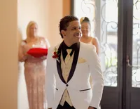 Venice Beach Los Angeles wedding photography of the groom looking back down the aisle to see if the bride is coming, captured in a candid documentary moment with true to life color and emotional
