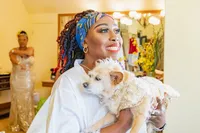 Venice Beach Los Angeles wedding photography of the bride getting ready with her small dog in wedding attire, captured in a candid documentary moment with true to life color and soft natural light.