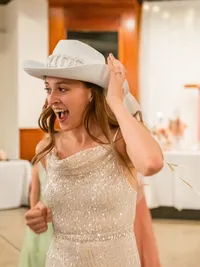 San Francisco'd bride with cowboy hat and white jumpsuit