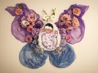 4Karma Studio - Fine art newborn portrait in San Francisco featuring a sleeping baby nestled in organic florals and rustic textures with true-to-life colors.
