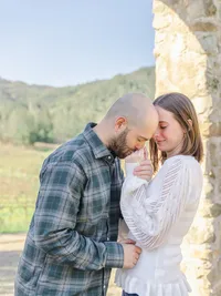 Man kissing his girlfriend’s hand during a romantic engagement photo session in Pasadena.