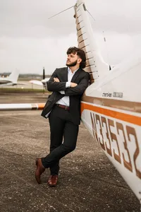 Senior portrait at a small hangar near Mobile International Airport in Mobile, Alabama — posing near airplane