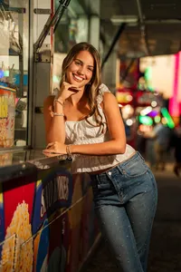 Senior portrait at the Greater Gulf State Fair in Mobile, Alabama — smiling with her arms resting
on a fried Oreo and funnel cake stand.