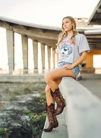 Senior portrait in Gulf Shores, Alabama — sitting on a rail