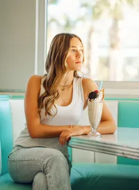 Senior portrait at Sunliner Diner in Gulf Shores, Alabama — sitting in a booth with a tall
milkshake topped with a cherry.