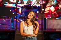 Senior portrait at the Greater Gulf State Fair in Mobile, Alabama — playing with her hair in front
of a twirling ride.