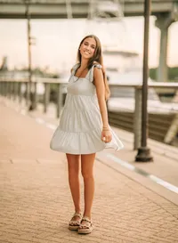 Senior portrait at The Wharf in Orange Beach, Alabama — twirling her dress with yachts in the
background.