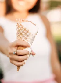 Senior portrait in Gulf Shores, Alabama — close-up of her class ring and a melting ice cream
cone outside TCBY.