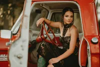 Senior portrait at Triple T Farms in Fruitdale, Alabama — sitting in a classic red truck.