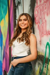 Senior portrait in downtown Mobile, Alabama — posing in front of some artwork.
