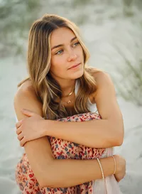 Senior portrait in Gulf Shores, Alabama — sitting on the beach.