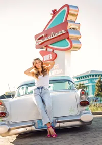 Senior portrait at Sunliner Diner in Gulf Shores, Alabama — sitting on the trunk of a white
classic car with the diner sign in the background.