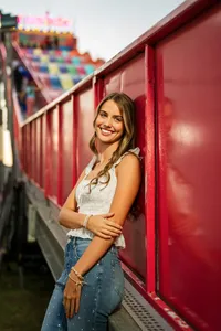 Senior portrait at the Greater Gulf State Fair in Mobile, Alabama — leaning against the slide
ride.