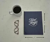 Time Magic Planner beside a coffee mug and glasses, ready for a weekly planning session.