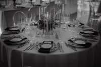 Table de réception dressée avec chandeliers en verre, verrerie en cristal et assiettes à motifs, centre de table végétal, ambiance élégante au Centre des sciences de Montréal