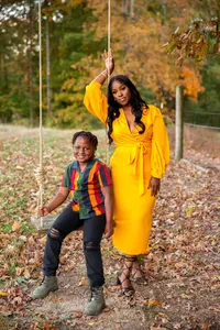 Mother and son smiling on swing