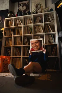 Iowa non-traditional senior session with vintage record studio senior sitting with vinyl record over their face