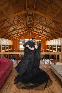 Iowa non-traditional couple dip black dress at wedding venue