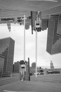 Black and white artistic double exposure portrait of senior in urban downtown skyscraper rooftop