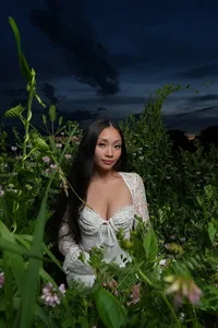 Iowa Des Moines grays lake senior sitting in natural grassy field during twilight