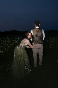 Baqara Tattooed pierced Bride playfully grabs groom during couple's wedding portrait sunset session