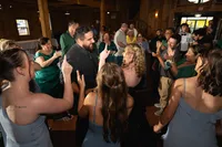 Iowa Wedding Reception bride and groom dancing in crowd at three sisters barn