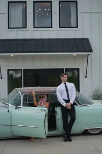 Iowa Wedding Old Money bride and groom in tiffany blue vintage car outside Walnut Ridge wedding venue