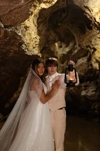 Tatted pierced bride with groom at Iowa state park cave portraits with lantern