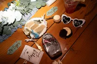 Moody Edgy Alternative Wedding Party Reception Detail Photo with half eatten cake, smashed coors light can, happy tears napkins, heart shaped sunglasses Baqara Wedding Venue Iowa