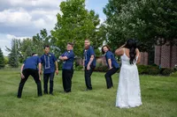 Iowa wedding Groomsmen portraits with the bride's reaction at the Monroe