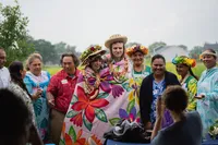 Non-Traditional Iowa Polynesian styled wedding couple draped under traditional love blanket during their tahitian - american blended wedding