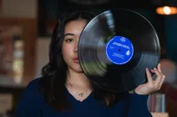Iowa senior session artistic photographer record studio in des moines iowa holding a vintage record