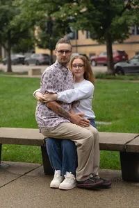 Iowa non-traditional couple inspired pose by mastermind couple embracing in a seated position