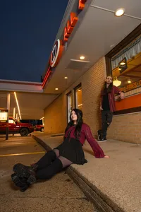 Iowa non-traditional engagement session outside A&W in Indianola for alt couple septum piercing wearing black an dr. Martens