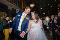 Tattooed Bridge and Groom exit with rice confetti outside Dirty Bird Restaurant Omaha Nebraska Wedding Elopement Photographer