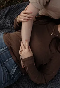 A close-up detail from a couple’s photoshoot in Maine, highlighting their hands and subtle connection. Fine art lifestyle photography by Damini Photography capturing intimate, romantic, and heartfelt moments.