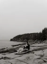Couple embracing along the rocky coast of Acadia National Park in Maine during a romantic photography session