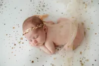 Best Baby Photographer in Charleston, SC poses Infant for Newborn Photoshoot.