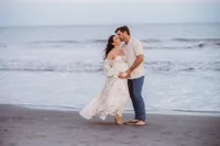 Charleston Beach Maternity Photographer -- Expectant parents pose for Maternity Photos on Folly Beach, SC.