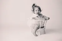 Charleston Cake Smash Photographer- Baby looks into the camera during Milestone Portraits at Holy City Babies Portrait Studio in Charleston, SC.