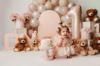 Charleston Cake Smash Photographer- Baby looks into the camera during Cake Smash Photos at Holy City Babies Portrait Studio in Charleston, SC.
