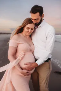 Charleston Beach Maternity Photographer -- Expectant parents pose for Maternity Photos on Folly Beach, SC.