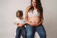 Expectant Mother poses with her toddler for Studio Maternity Portraits in Charleston, South Carolina.