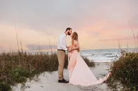 Charleston Beach Maternity Photographer -- Expectant parents pose for Maternity Photos on Folly Beach, SC.