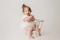 Charleston Cake Smash Photographer -- Baby celebrates her first birthday with a Cake Smash Photoshoot at Holy City Babies Portrait Studio in Charleston, SC.