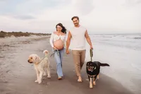 Charleston Beach Maternity Photographer -- Expectant parents pose for Maternity Photos on Folly Beach, SC.